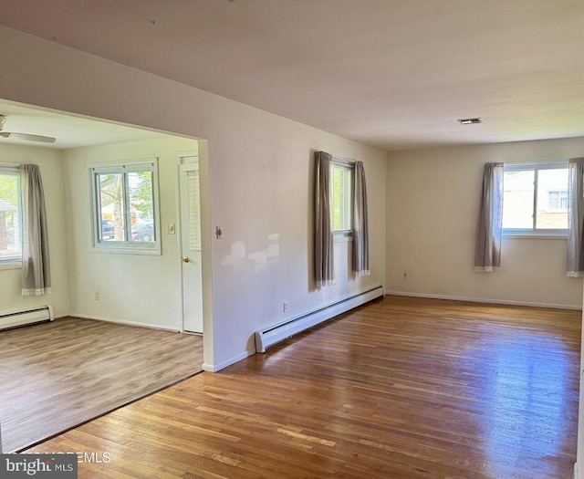 11 Cardinal St Unit D, Manchester, NJ 08759 - spare room featuring a baseboard heating unit, wood finished floors, baseboards, a ceiling fan, and baseboard heating
