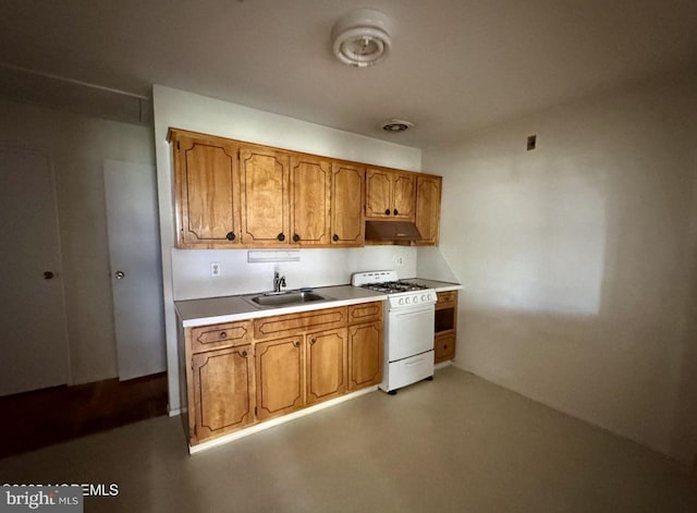 11 Cardinal St Unit D, Manchester, NJ 08759 - kitchen with white gas range oven, a sink, brown cabinets, and light countertops