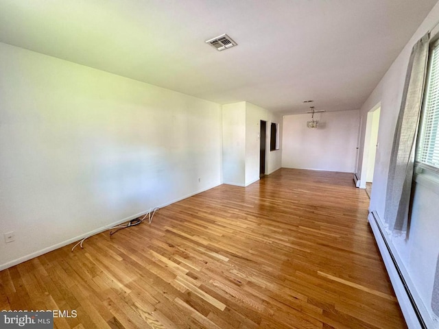 11 Cardinal St Unit D, Manchester, NJ 08759 - unfurnished room with baseboard heating, light wood finished floors, baseboards, and a chandelier