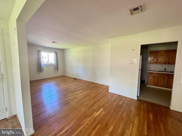 11 Cardinal St Unit D, Manchester, NJ 08759 - unfurnished room featuring wood finished floors, a sink, and baseboards