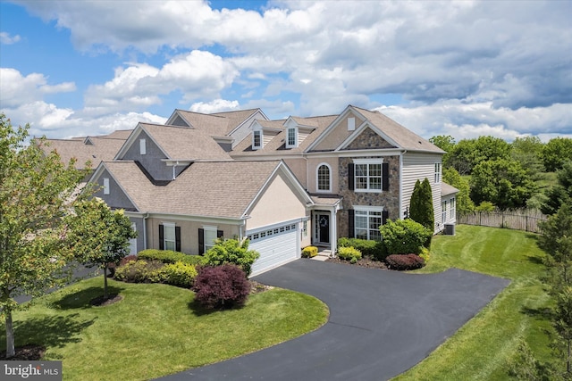 501 Jasmine Cir, Upper Gwynedd, PA 19446 - view of front of home with asphalt driveway, stone siding, an attached garage, roof with shingles, and central AC