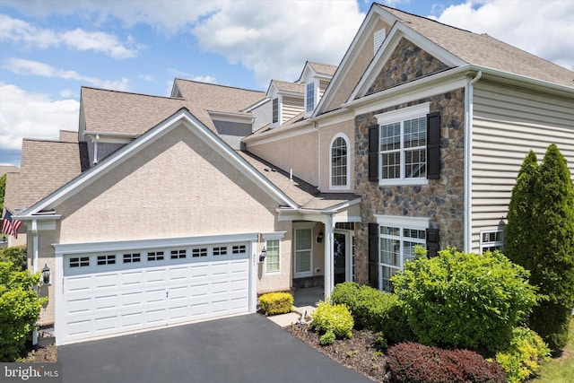 501 Jasmine Cir, Upper Gwynedd, PA 19446 - view of front of property with stone siding, asphalt driveway, an attached garage, and a shingled roof