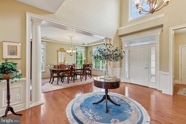 501 Jasmine Cir, Upper Gwynedd, PA 19446 - foyer entrance with a chandelier, wood finished floors, healthy amount of natural light, wainscoting, and a decorative wall