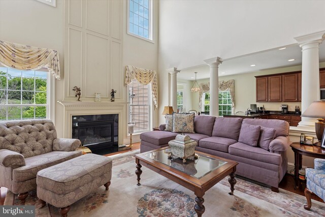 501 Jasmine Cir, Upper Gwynedd, PA 19446 - living area with a high ceiling, ornate columns, a large fireplace, and recessed lighting