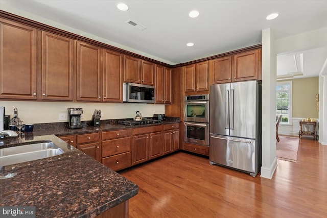 501 Jasmine Cir, Upper Gwynedd, PA 19446 - kitchen with stainless steel appliances, light wood-style flooring, a sink, recessed lighting, and dark stone counters