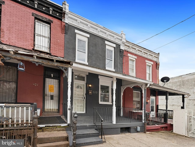 320 E Shedaker St, Philadelphia, PA 19144 - townhome / multi-family property featuring covered porch and brick siding