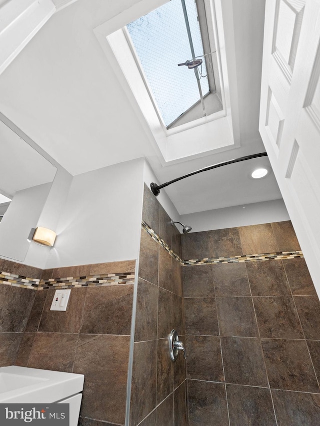 320 E Shedaker St, Philadelphia, PA 19144 - full bathroom featuring a skylight, tiled shower, tile walls, and recessed lighting