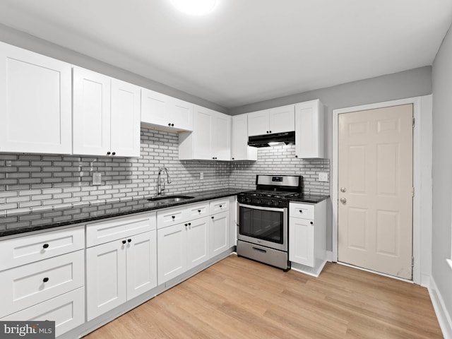 320 E Shedaker St, Philadelphia, PA 19144 - kitchen with stainless steel gas range, a sink, under cabinet range hood, white cabinetry, and decorative backsplash
