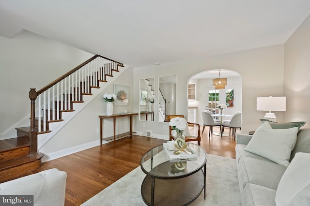 1312 Michigan Ave, Alexandria, VA 22314 - living area with arched walkways, stairs, wood finished floors, and baseboards