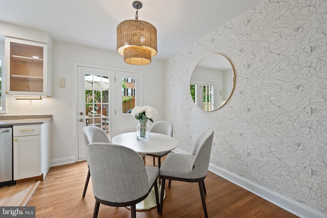 1312 Michigan Ave, Alexandria, VA 22314 - dining area with wallpapered walls, light wood-style flooring, baseboards, and a chandelier