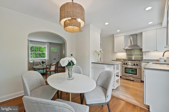 1312 Michigan Ave, Alexandria, VA 22314 - dining area with arched walkways, a chandelier, light wood-style flooring, baseboards, and recessed lighting
