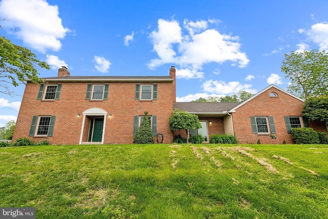 550 Font Rd, Downingtown, PA 19335 - colonial home with a chimney, brick siding, and a front lawn