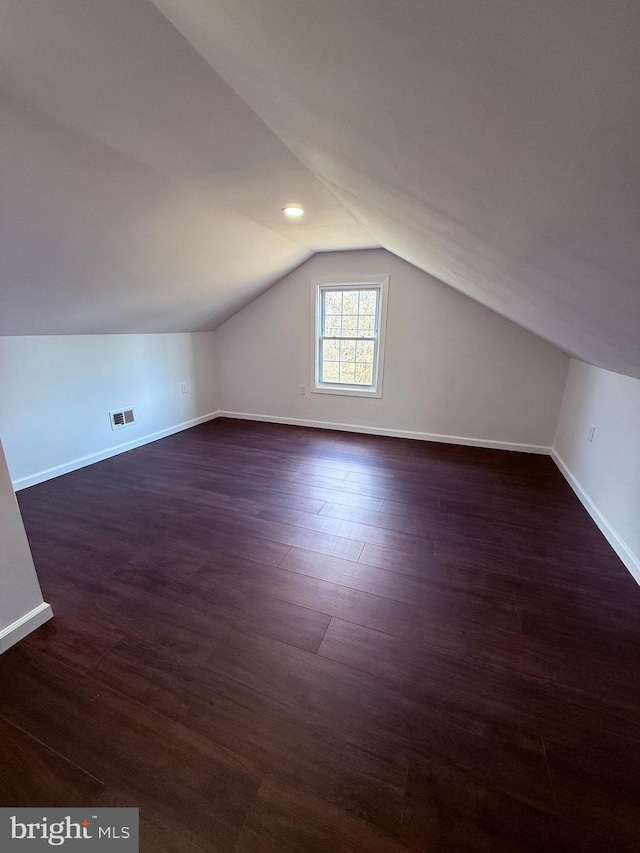 943 Columbus Rd, Burlington, NJ 08016 - additional living space featuring vaulted ceiling, baseboards, and dark wood-style flooring