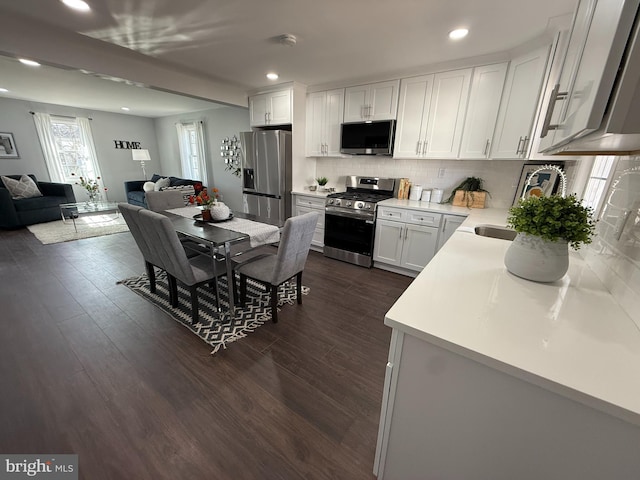 943 Columbus Rd, Burlington, NJ 08016 - kitchen featuring appliances with stainless steel finishes, open floor plan, dark wood-style floors, decorative backsplash, and recessed lighting
