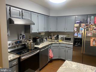 11306 Bent Creek Ter, Germantown, MD 20876 - kitchen with appliances with stainless steel finishes, under cabinet range hood, light countertops, gray cabinets, and a sink