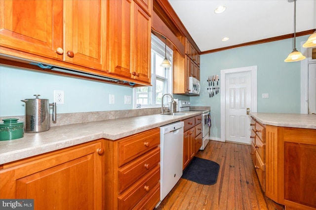 28 N Altamont Ave, Thurmont, MD 21788 - kitchen featuring white appliances, a sink, brown cabinets, crown molding, and wood finished floors