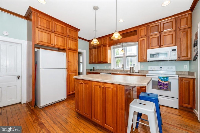 28 N Altamont Ave, Thurmont, MD 21788 - kitchen with white appliances, a sink, light countertops, hardwood / wood-style flooring, and a center island
