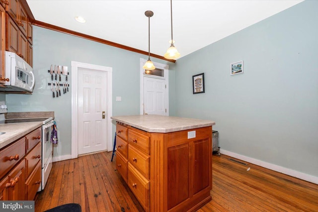 28 N Altamont Ave, Thurmont, MD 21788 - kitchen with white appliances, dark wood finished floors, a kitchen island, baseboards, and brown cabinetry