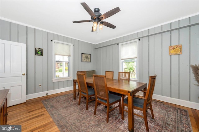 28 N Altamont Ave, Thurmont, MD 21788 - dining space featuring crown molding, wood finished floors, baseboards, a ceiling fan, and a decorative wall