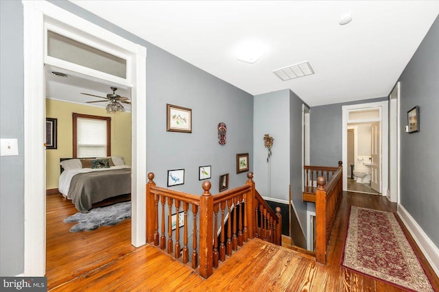 28 N Altamont Ave, Thurmont, MD 21788 - hallway with an upstairs landing, wood finished floors, and baseboards
