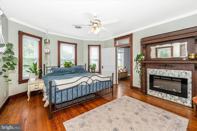 28 N Altamont Ave, Thurmont, MD 21788 - bedroom with baseboards, wood finished floors, crown molding, a glass covered fireplace, and ceiling fan