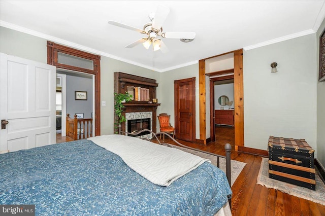 28 N Altamont Ave, Thurmont, MD 21788 - bedroom with wood finished floors, ornamental molding, baseboards, a stone fireplace, and ceiling fan