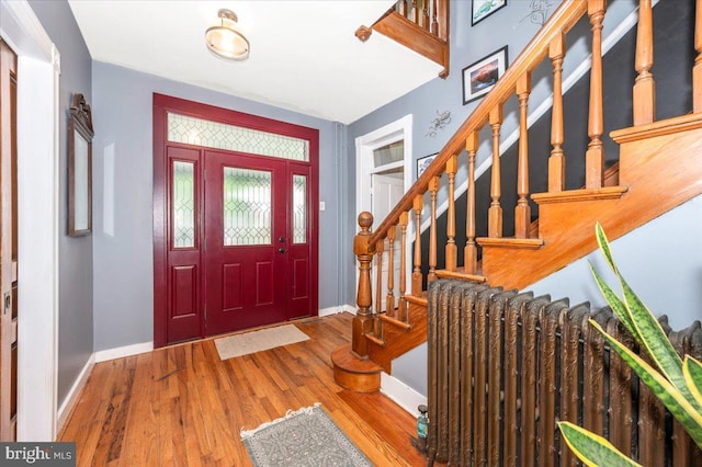 28 N Altamont Ave, Thurmont, MD 21788 - entryway with baseboards, radiator, wood finished floors, and stairway