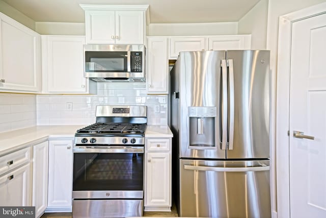 25083 Aspen Cir, Millsboro, DE 19966 - kitchen featuring stainless steel appliances, white cabinetry, light countertops, and tasteful backsplash