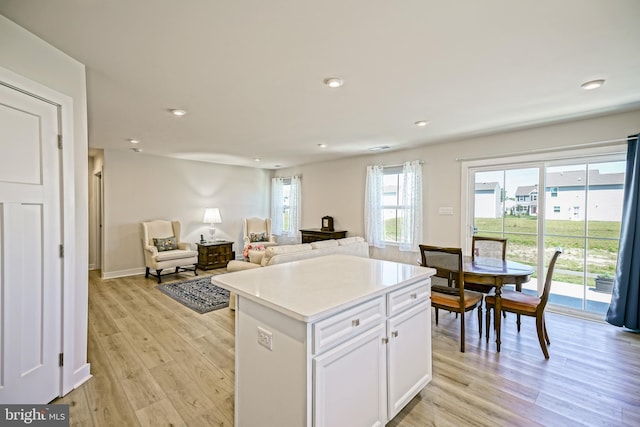 25083 Aspen Cir, Millsboro, DE 19966 - kitchen with white cabinetry, light wood-style floors, a center island, recessed lighting, and light countertops