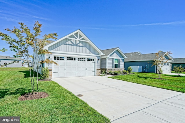 25083 Aspen Cir, Millsboro, DE 19966 - view of front facade featuring board and batten siding, stone siding, driveway, and a front yard