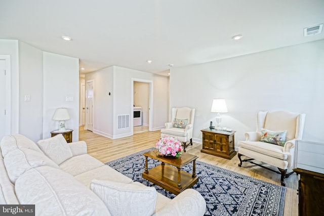 25083 Aspen Cir, Millsboro, DE 19966 - living area featuring light wood-style floors, washer / dryer, recessed lighting, and baseboards
