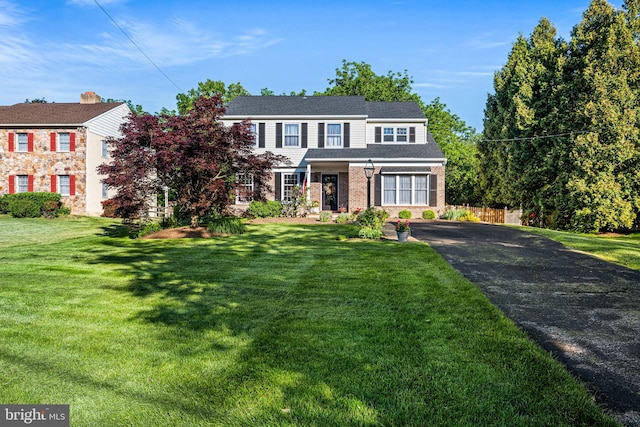 14 Auchy Rd, Erdenheim, PA 19038 - view of front facade featuring asphalt driveway and a front yard