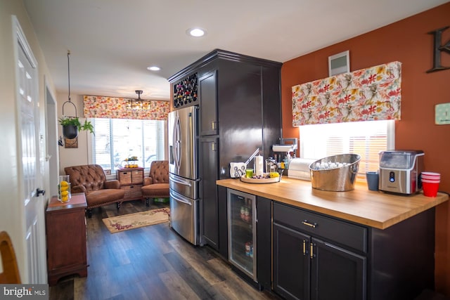 1211 Birch Ave, Baltimore, MD 21227 - kitchen featuring stainless steel fridge, butcher block countertops, beverage cooler, dark wood-type flooring, and recessed lighting