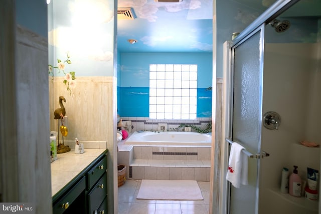 1211 Birch Ave, Baltimore, MD 21227 - full bath featuring vanity, a garden tub, a shower stall, and tile patterned flooring