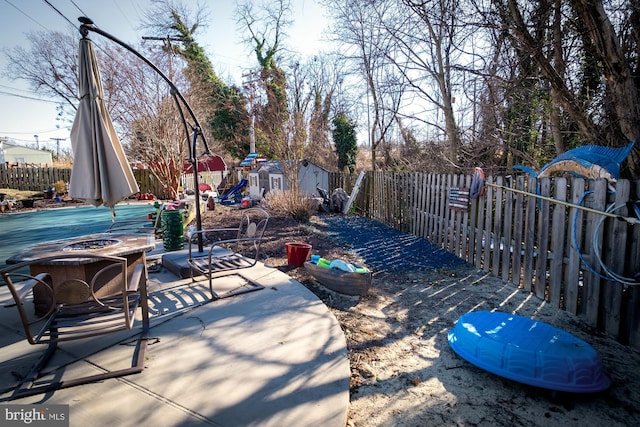 1211 Birch Ave, Baltimore, MD 21227 - fenced backyard featuring a patio and an outdoor fire pit