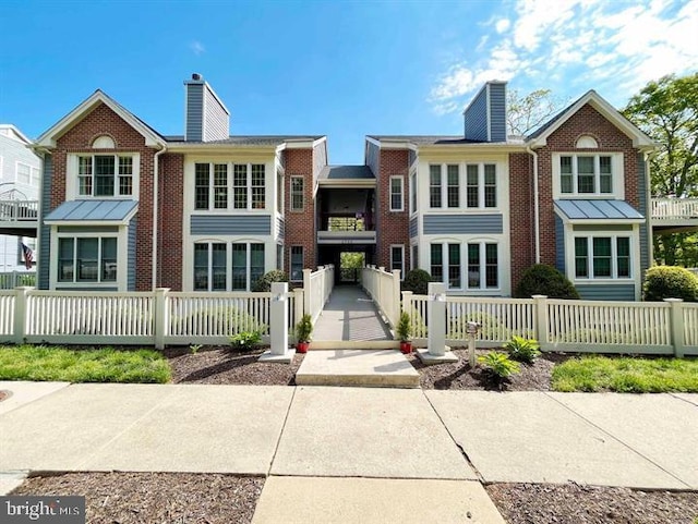2700 Summerview Way Unit 101, Annapolis, MD 21401 - view of front of property featuring a chimney, brick siding, and a fenced front yard