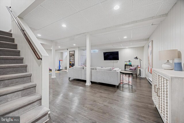 237 Trianon Ln, Villanova, PA 19085 - living area featuring stairs, dark wood-style floors, a paneled ceiling, a baseboard heating unit, and recessed lighting