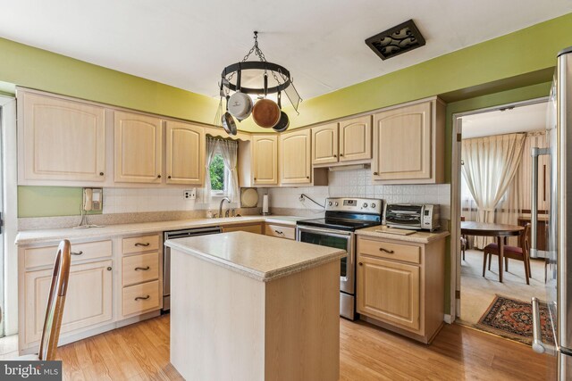 5 S Syracuse Dr, Cherry Hill, NJ 08034 - kitchen featuring appliances with stainless steel finishes, light brown cabinetry, light countertops, light wood-type flooring, and tasteful backsplash