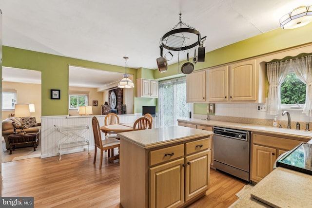 5 S Syracuse Dr, Cherry Hill, NJ 08034 - kitchen featuring dishwashing machine, a sink, light countertops, light wood-style floors, and a wainscoted wall