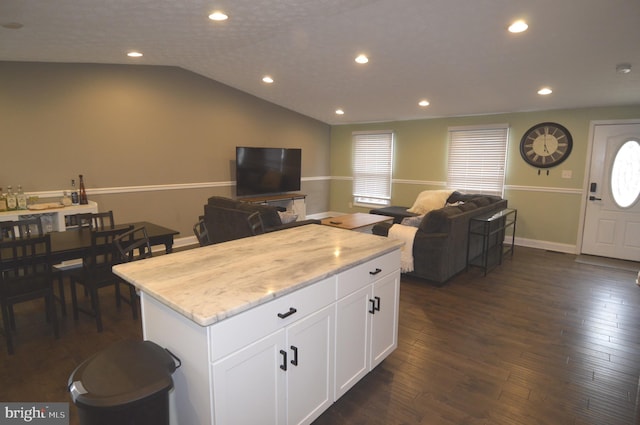 507 Fuselage Ave, Baltimore, MD 21221 - kitchen with open floor plan, a kitchen island, white cabinets, light stone counters, and dark wood finished floors