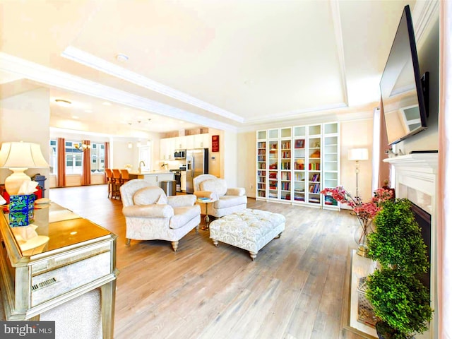 4737 Earl Flanagan Way, Alexandria, VA 22309 - living area featuring a tray ceiling, crown molding, a premium fireplace, and light wood finished floors