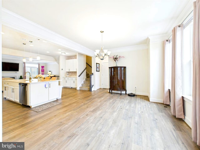 4737 Earl Flanagan Way, Alexandria, VA 22309 - kitchen featuring open floor plan, white cabinetry, a chandelier, ornamental molding, and light countertops