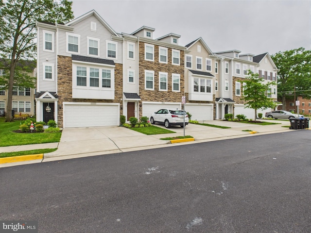 4737 Earl Flanagan Way, Alexandria, VA 22309 - townhome / multi-family property with stone siding, driveway, and a garage