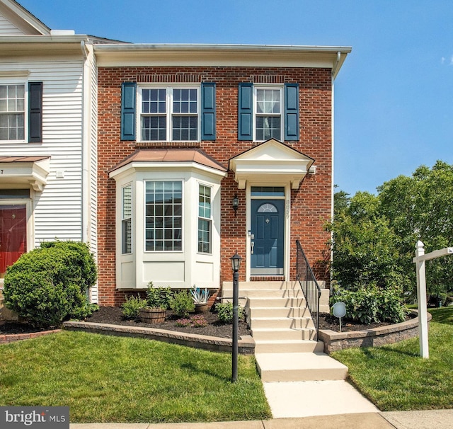 8859 Howland Pl, Bristow, VA 20136 - view of front of home featuring brick siding and a front lawn