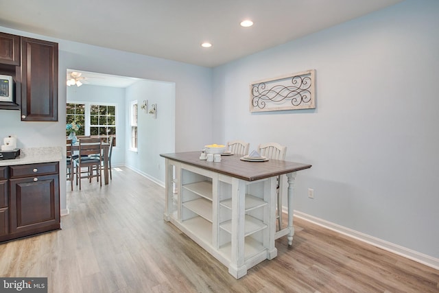 8859 Howland Pl, Bristow, VA 20136 - kitchen featuring dark brown cabinets, light wood finished floors, recessed lighting, open shelves, and light countertops