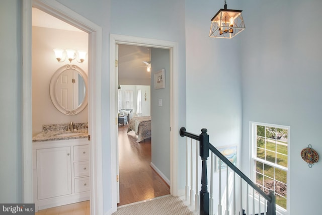 8859 Howland Pl, Bristow, VA 20136 - hallway featuring an upstairs landing and a chandelier