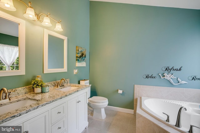 8859 Howland Pl, Bristow, VA 20136 - bathroom with a garden tub, double vanity, and tile patterned flooring