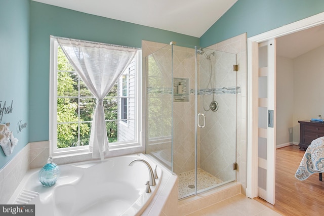 8859 Howland Pl, Bristow, VA 20136 - full bathroom featuring a garden tub, a stall shower, lofted ceiling, and wood finished floors
