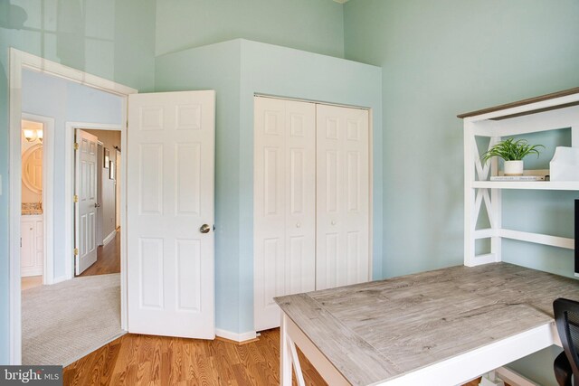 8859 Howland Pl, Bristow, VA 20136 - home office featuring a towering ceiling and wood finished floors