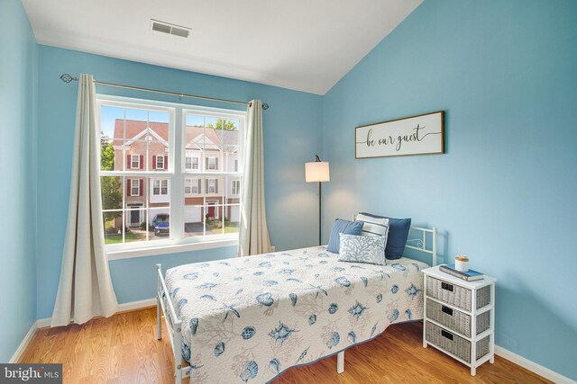 8859 Howland Pl, Bristow, VA 20136 - bedroom with wood finished floors and vaulted ceiling